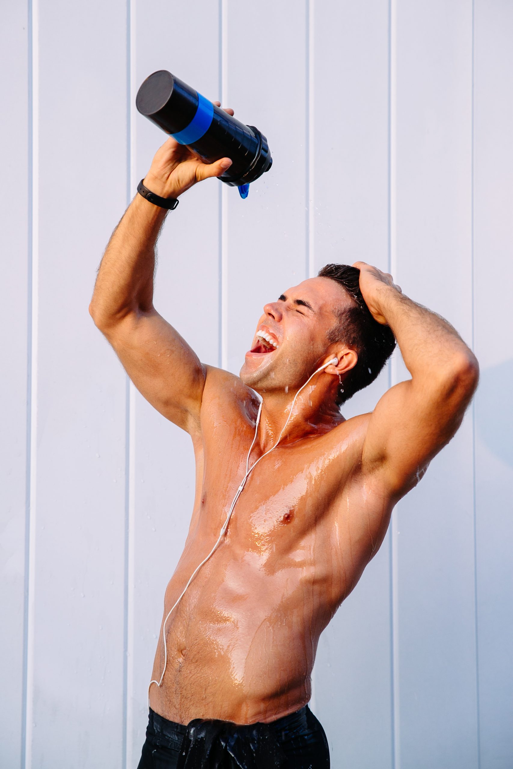 happy muscular guy pouring out water from bottle his body sweating after training scaled - Unveiling Men's Intimate Hygiene: Addressing Unique Needs Navigating Hygiene Differences and Tips for Active Lifestyles